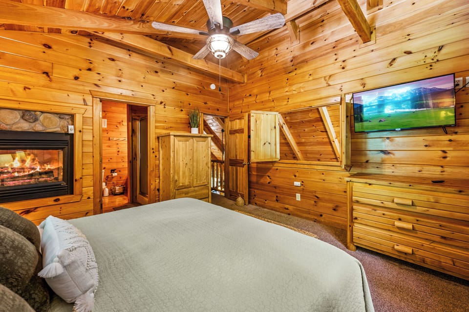 Indulge in luxury in our master bedroom with a flat-screen TV and a romantic double-sided gas fireplace for the perfect retreat