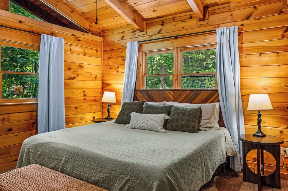 Experience ultimate comfort in our master bedroom, featuring plush pillows, cozy bedding, and a luxurious king mattress for a restful night's sleep.