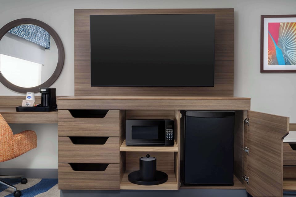 Desk, laptop workspace, blackout drapes, bed sheets