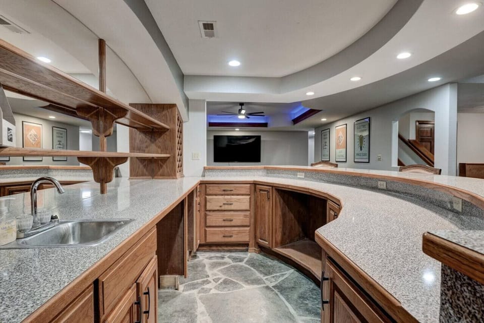Marble table with a wide surface and plenty of storage, including cabinets below and an integrated sink.