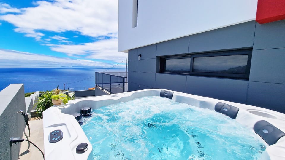 The luxurious 6+ person jacuzzi at Azure Serenity Villa offers a relaxing experience with stunning ocean and mountain views in Gaula, Santa Cruz Madeira. Perfect for a serene getaway. #jacuzzi #oceanview