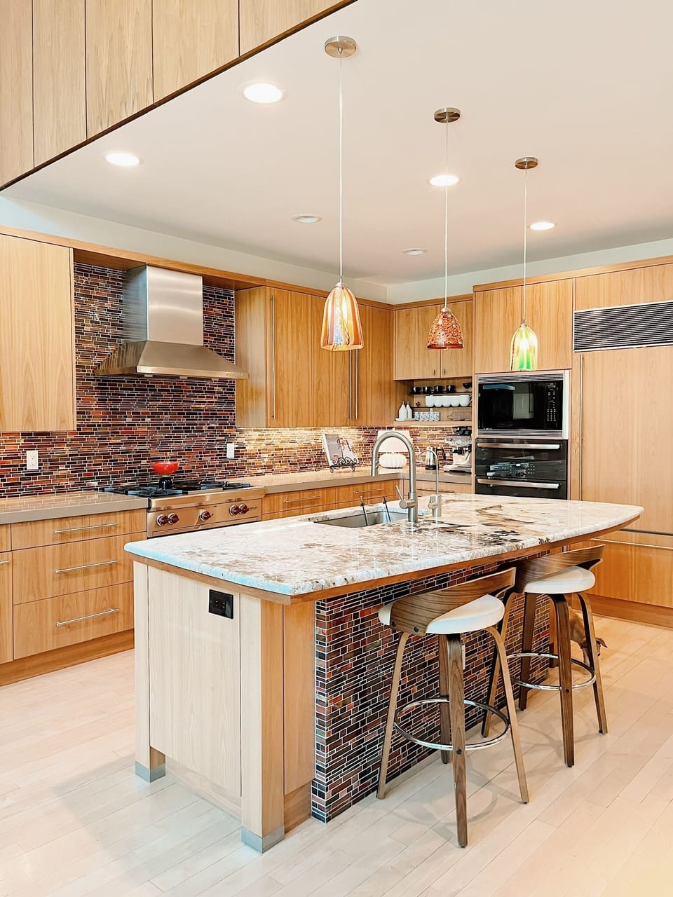 Jenn Air, Bosch, Sub Zero kitchen with Wolf double oven and chef's gas range.