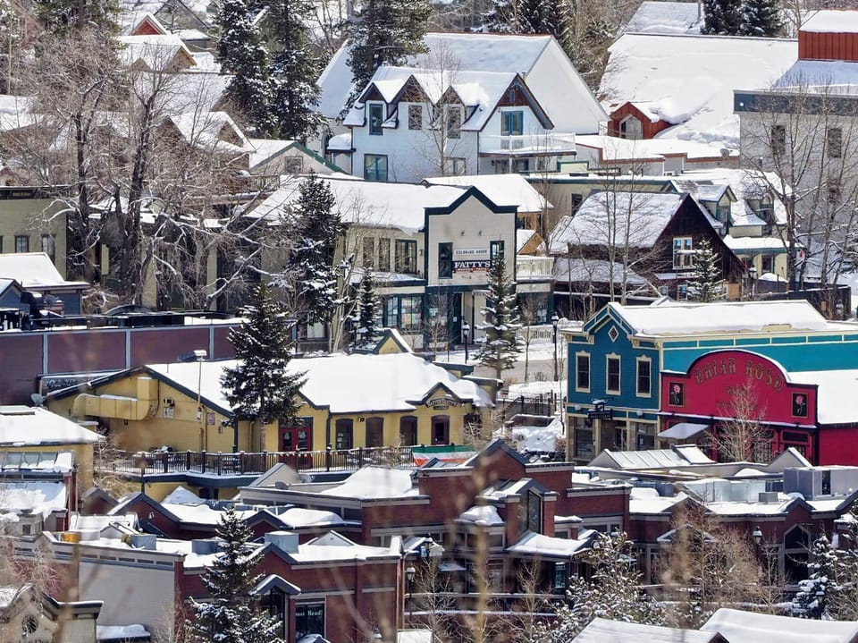 Colorful mountain town covered in fresh snow.