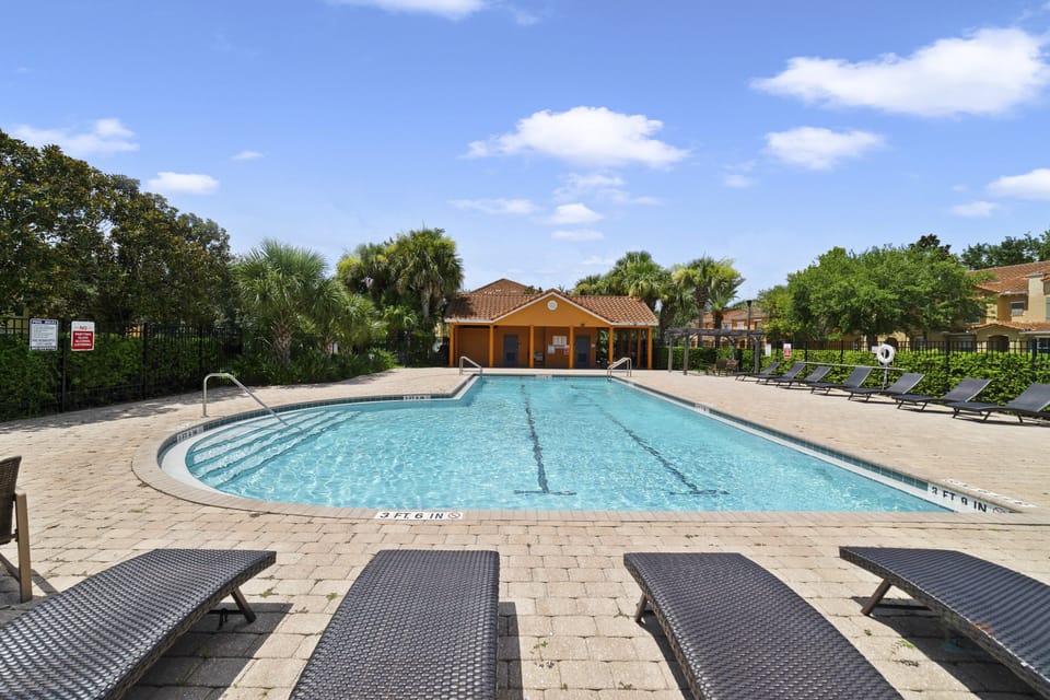 Inviting outdoor pool with sun loungers, perfect for relaxation and family fun.