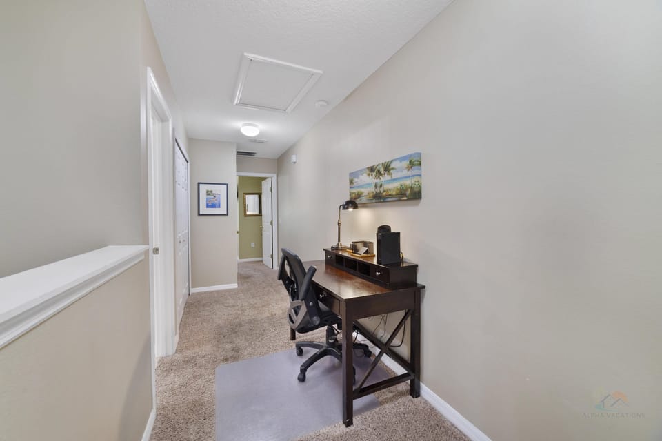 Cozy hallway workspace with desk and comfortable chair, ideal for remote work or study.