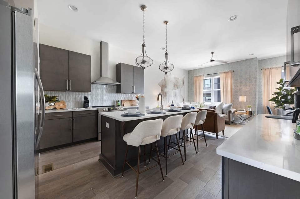 Clean and Spacious Kitchen with Sleek Countertops and Additional Seating