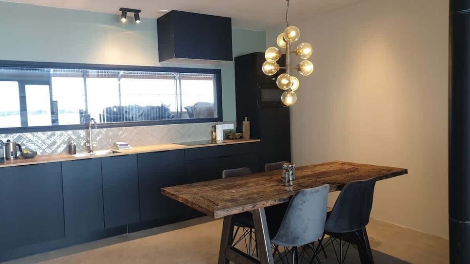 Kitchen with all facilities, dining table and a view of the cows.