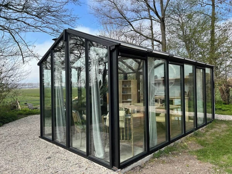 Exterior of the glass cabinet with a living space and kitchen.