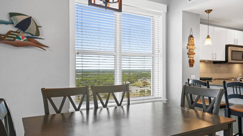 Gather around your dining table while savoring scenic views through expansive windows, creating the perfect backdrop for memorable meals together.