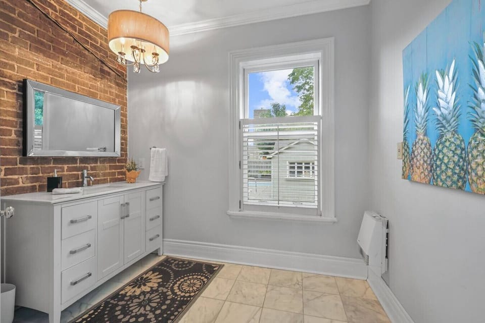 Refresh and recharge in this bright and charming bathroom. With modern fixtures and a stylish vanity, it offers a serene and comfortable space to get ready for your day or wind down for the night.