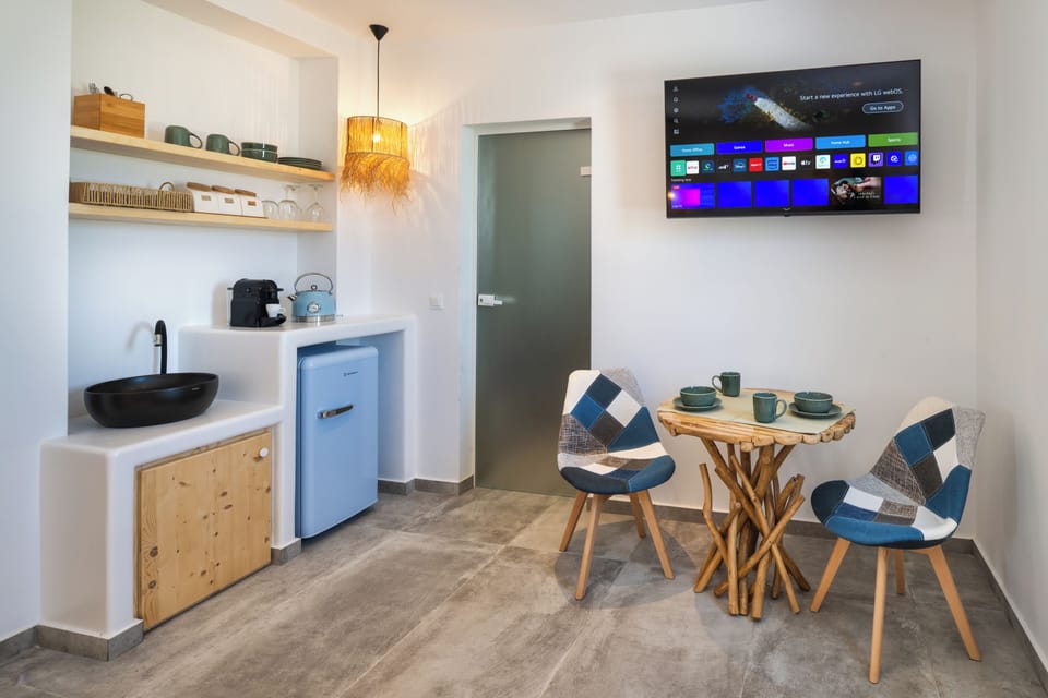 Aeolos Suite with Private Hot Tub | Living area | 32-inch flat-screen TV with cable channels