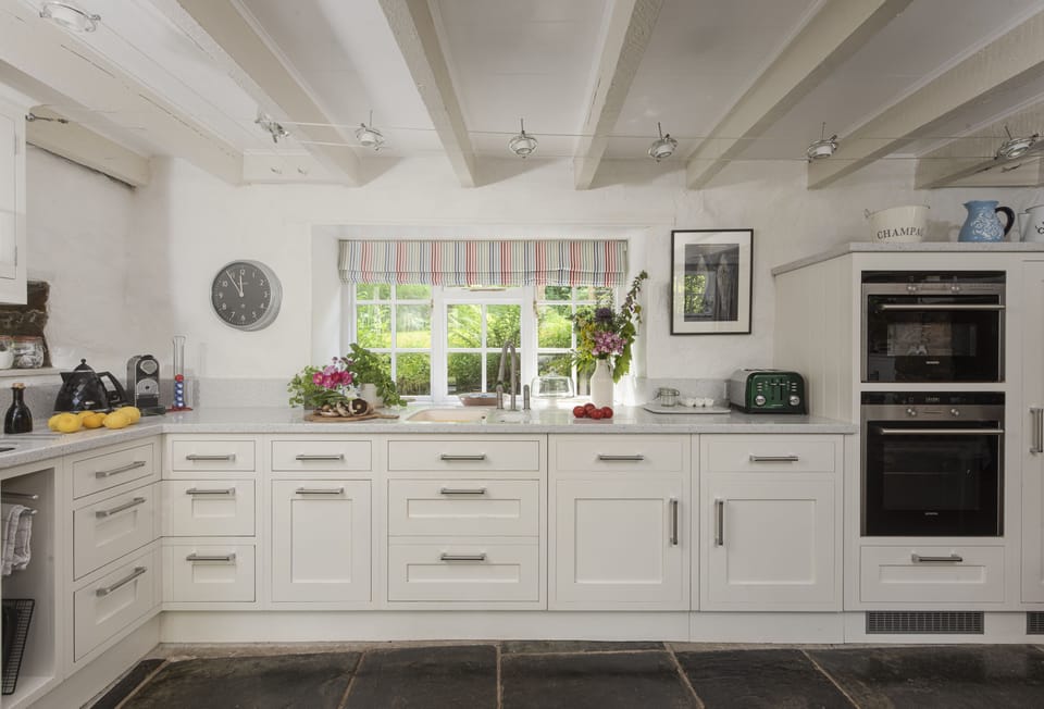 The Watermill, Withiel: The beautifully finished kitchen is complete with a double electric oven, induction hob, microwave, fridge with ice box, dishwasher, washer/dryer and a Nespresso coffee machine