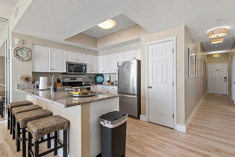 Kitchen has GULF VIEWS, granite countertops, stainless appliances - fully stocked with more than the basics (coffee/tea bar, oils/salt and pepper, Tupperware, plenty of pots/pans/cookware)