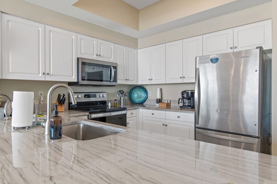 Kitchen has GULF VIEWS, granite countertops, stainless appliances - fully stocked with more than the basics (coffee/tea bar, oils/salt and pepper, Tupperware, plenty of pots/pans/cookware)