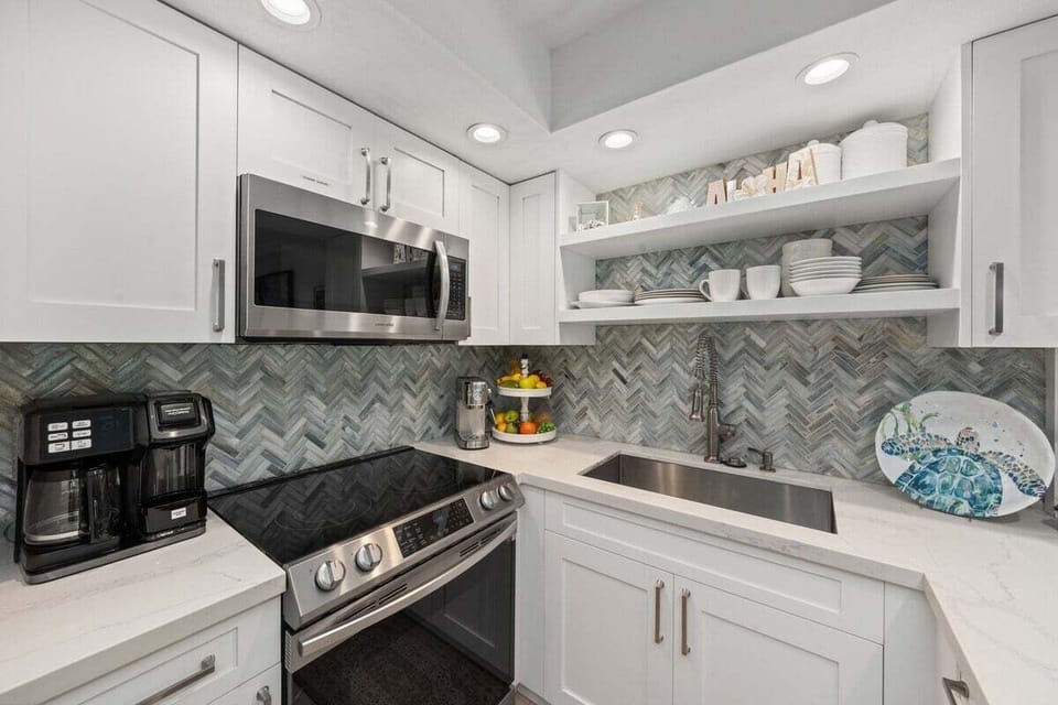 Cook in kitchens brightened by chevron and steel.