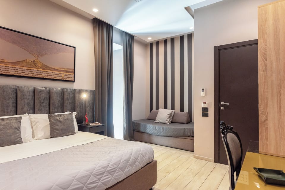Classic Quadruple Room | Minibar, in-room safe, desk, laptop workspace