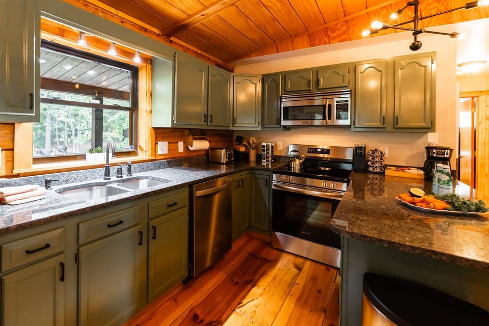 A fully-stocked kitchen with modern appliances, rustic wood accents, and a convenient tea/coffee bar, perfect for home-cooked meals during your stay.