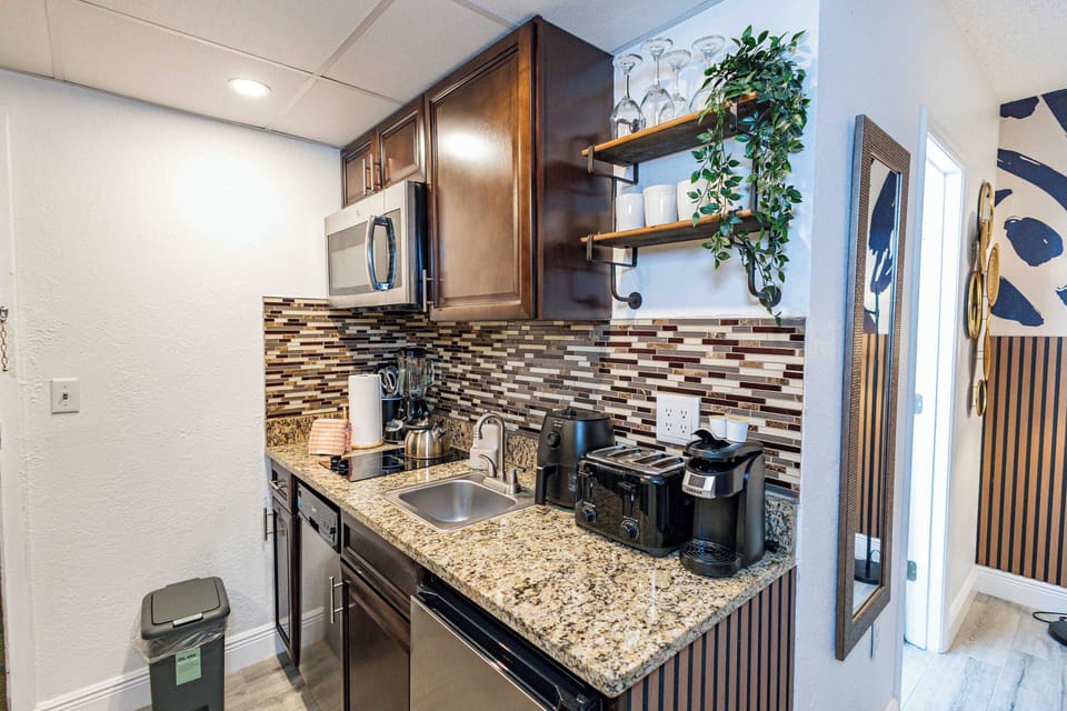 Full kitchen with freezer, stove, microwave, coffee maker, toaster, dishwasher