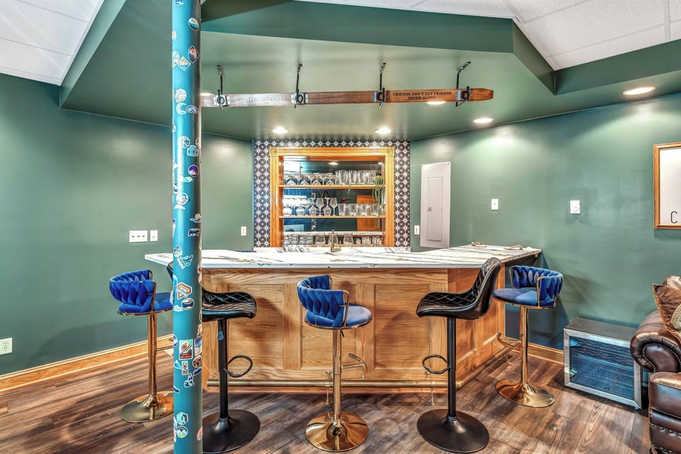 Basement with a Smart TV, full bar, extra seating, pool table, arcade game, dart board, with attached bathroom.