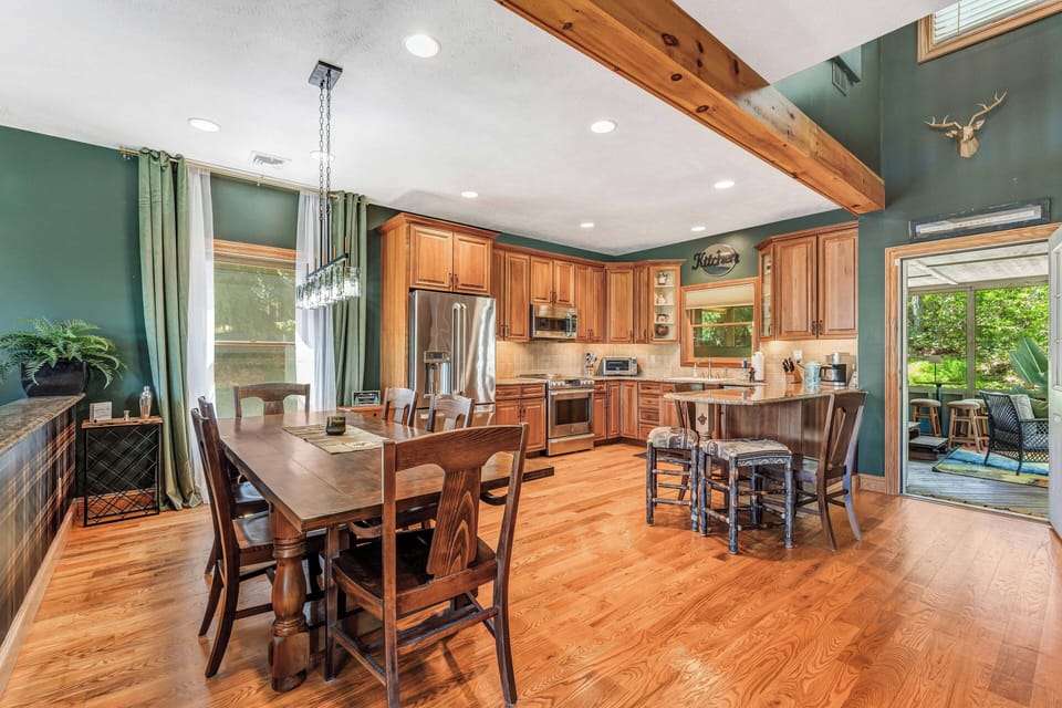 The dining area flows beautifully into the modern kitchen, which boasts upgraded stainless steel appliances and custom cabinets—ideal for creating gourmet meals while enjoying the lovely views!
