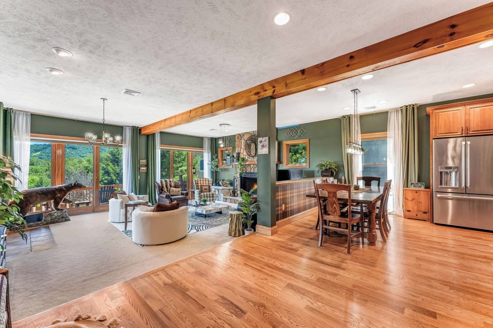 The dining area flows beautifully into the modern kitchen, which boasts upgraded stainless steel appliances and custom cabinets—ideal for creating gourmet meals while enjoying the lovely views!