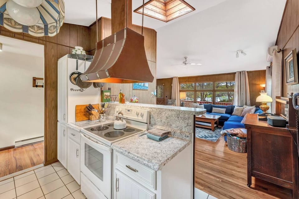 Kitchen & Living Area: Embrace lake views through large windows while cooking in style!