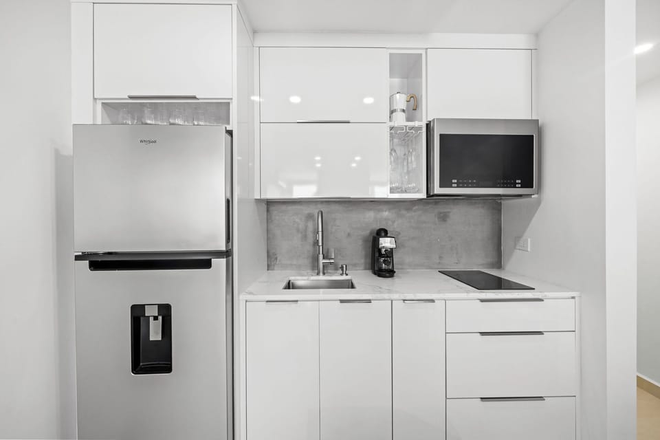 Modern white cabinetry with stainless steel appliances
