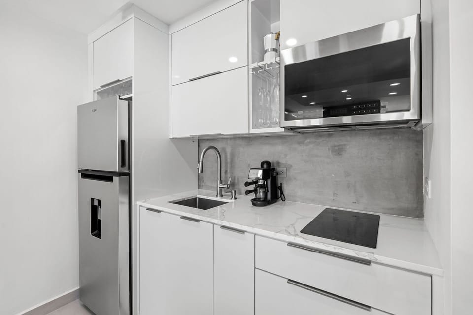The unit includes a modern and sleek fully equipped kitchen.