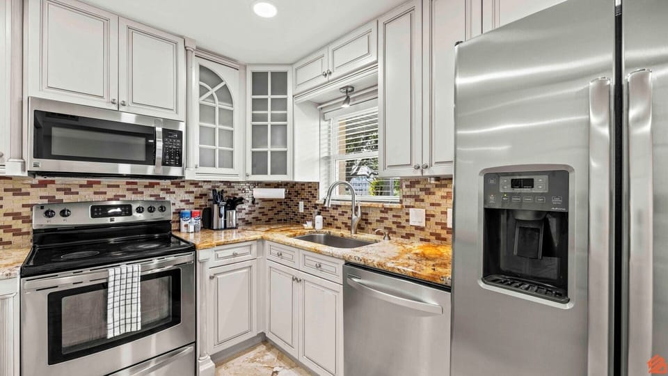 Fully equipped with modern appliances and plenty of counter space.