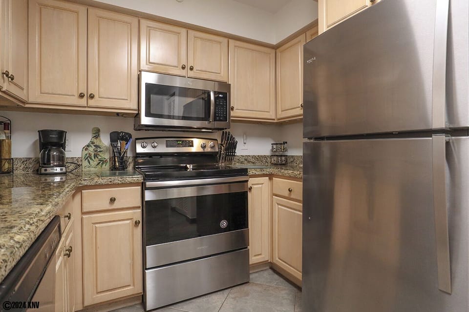 Newly remodeled Kitchen has beautiful cabinetry, new appliances and granite countertops.