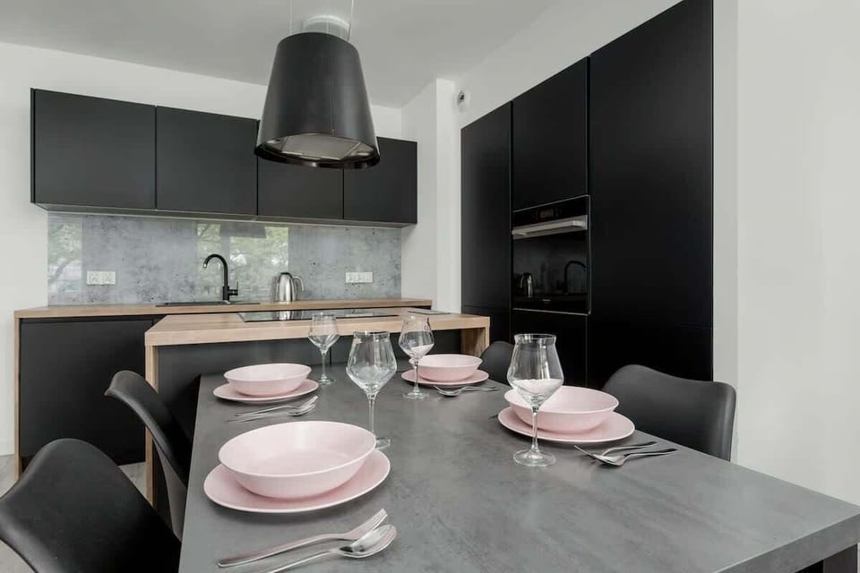 Airy dining area in the living room, set for four.
