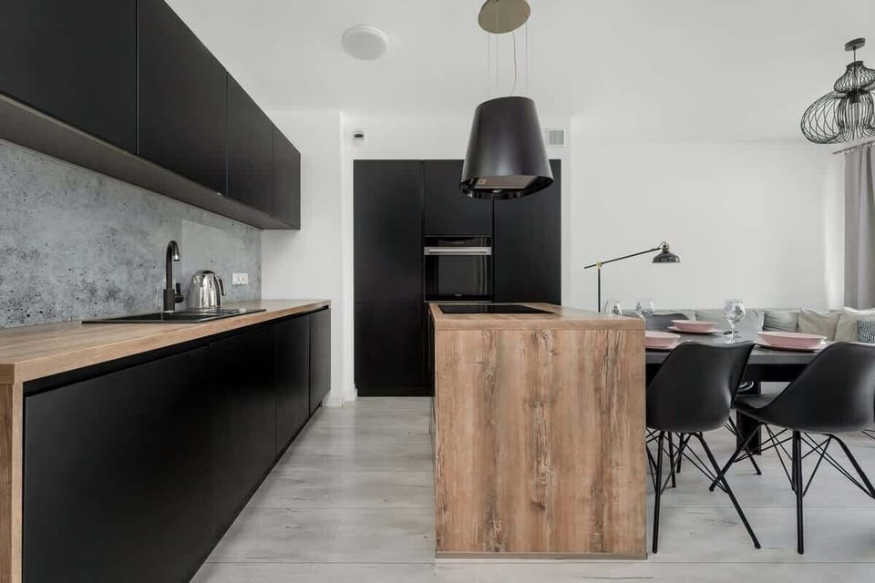 Contemporary kitchen with a dining island, modern lighting, and seamless open-plan layout.