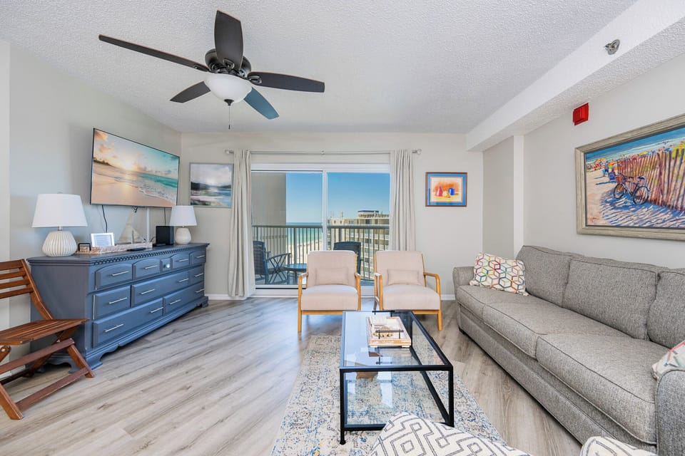 Natural light fills the living room as you relax on the sofa and enjoy the distant beach view from your balcony