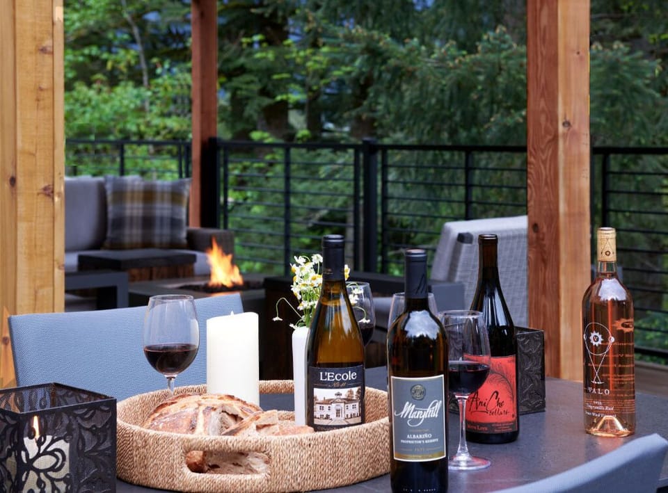 Enjoy outdoor dining on the deck with a beautiful forest backdrop and cozy ambiance.