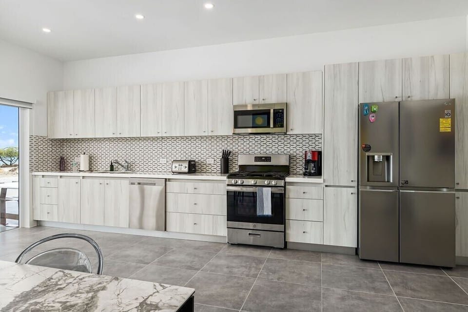 Kitchen
Fuel your stay with warmth and flavor in our welcoming kitchen. It's more than just a room; it's the heart of our home.
