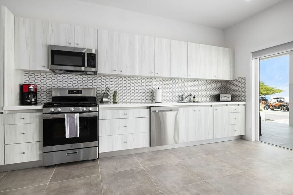 Kitchen
Experience culinary excellence in our fully-equipped kitchen. From gourmet meals to cozy gatherings, every dish is crafted with love in your home away from home.