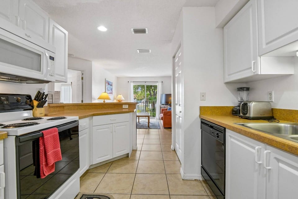 Well-stocked kitchen with essential appliances, cookware, and utensils