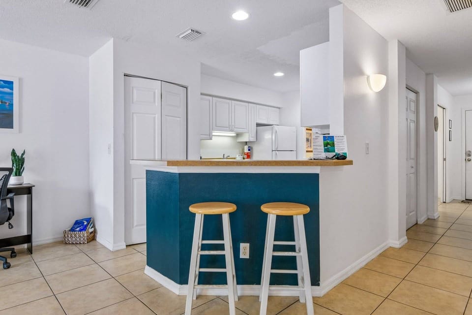 Open kitchen with breakfast bar seating—great for casual dining or morning coffee