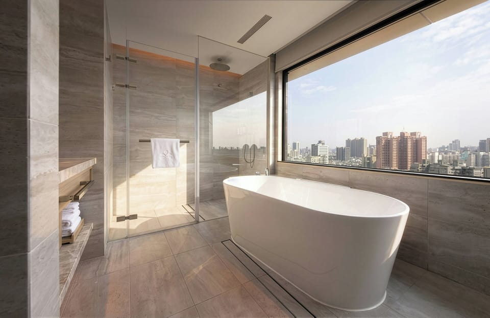 Deluxe Room, 1 King Bed, Corner | Bathroom | Hair dryer, slippers, electronic bidet, towels