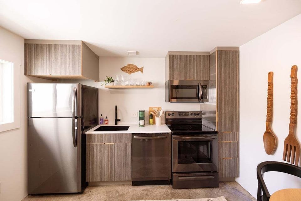 Fully equipped modern kitchen with stainless steel appliances, cooking essentials, and a Keurig coffee maker