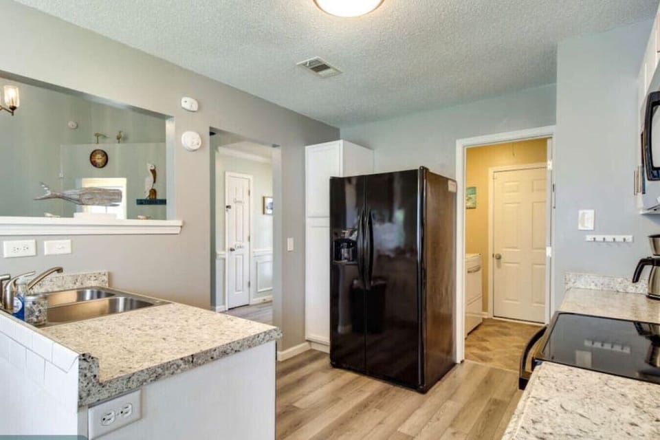 Open-concept kitchen seamlessly blending into living room, great for entertaining and family gatherings.
