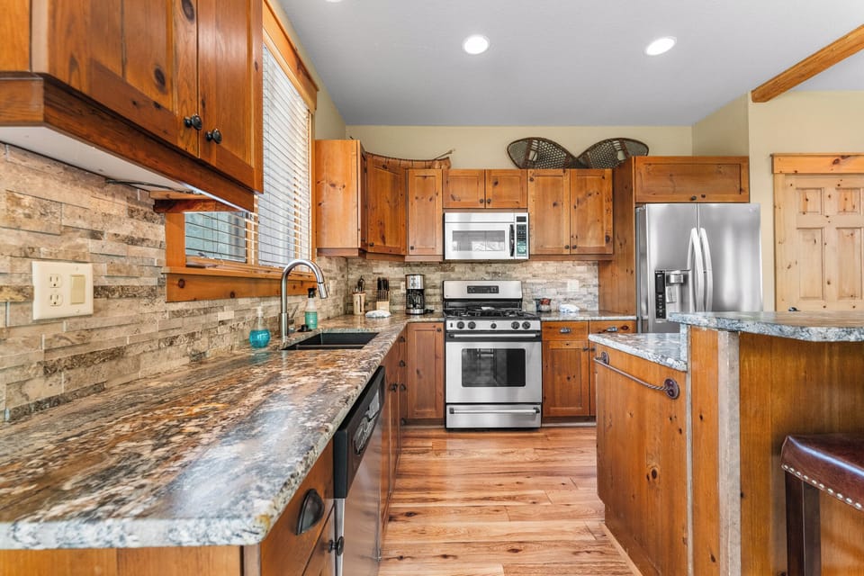 Full-size kitchen with granite countertops and stainless steel appliances.