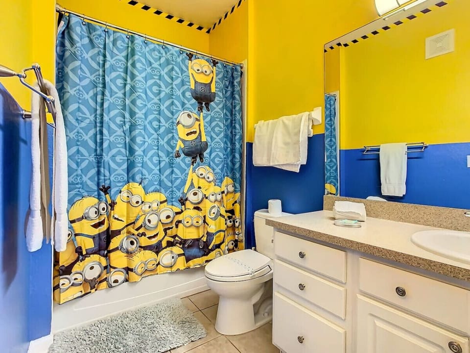 Minions-themed shared bathroom with shower/tub combo, conveniently located in the hallway.