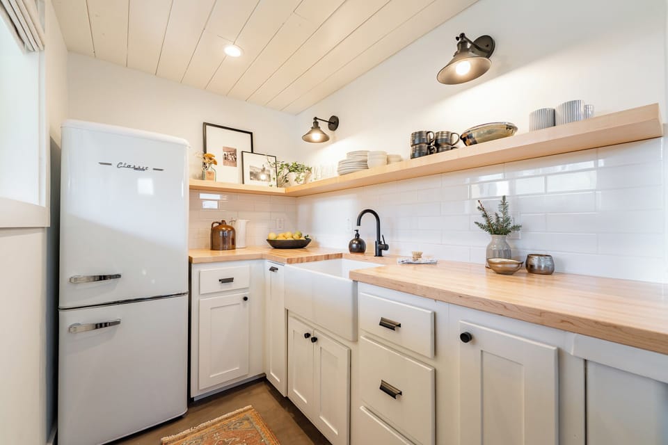 The kitchen has a nice-sized refrigerator.
