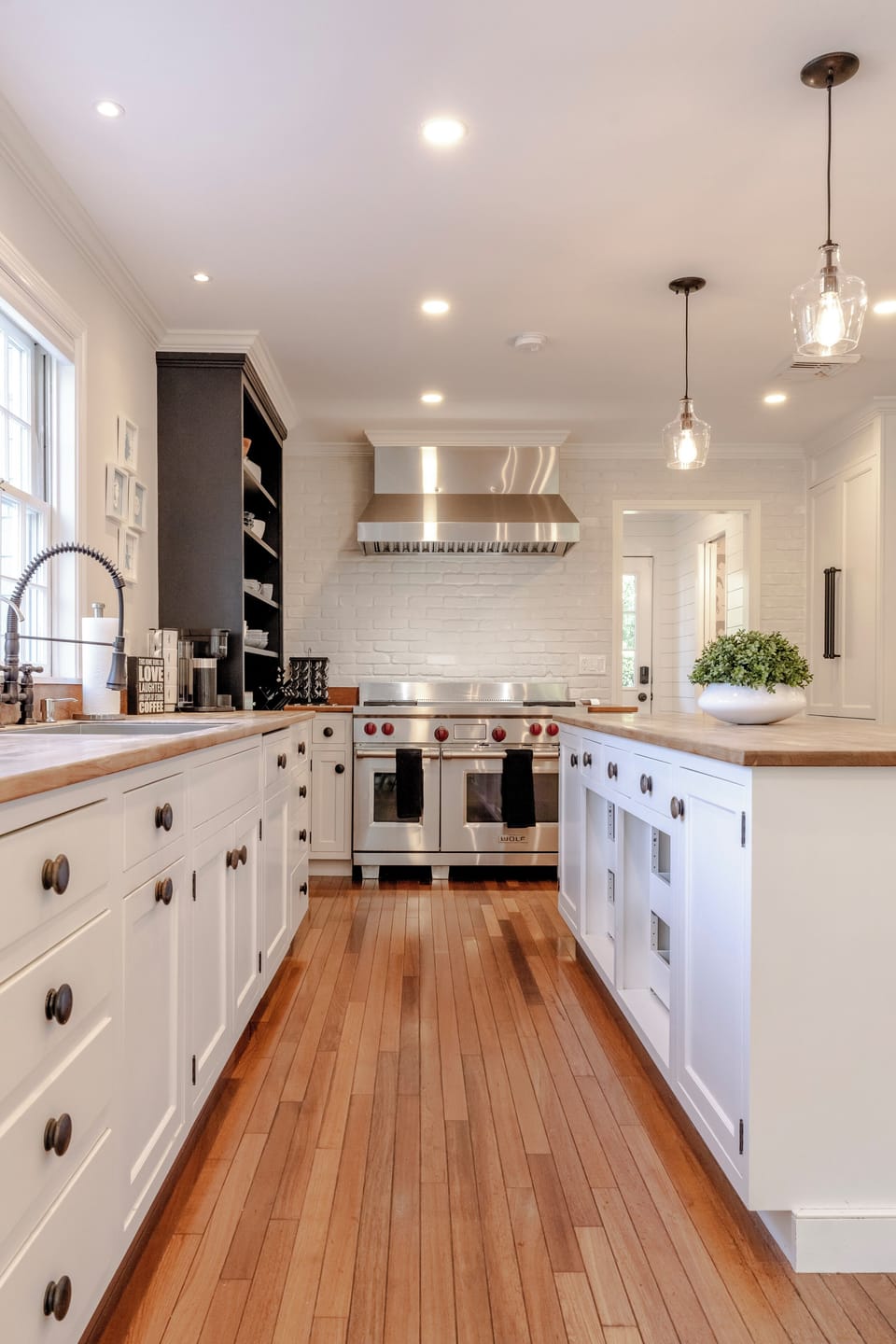 Chef's kitchen w/ Wolf Double oven, Bosch appliances & Sub-Zero wine fridge.
