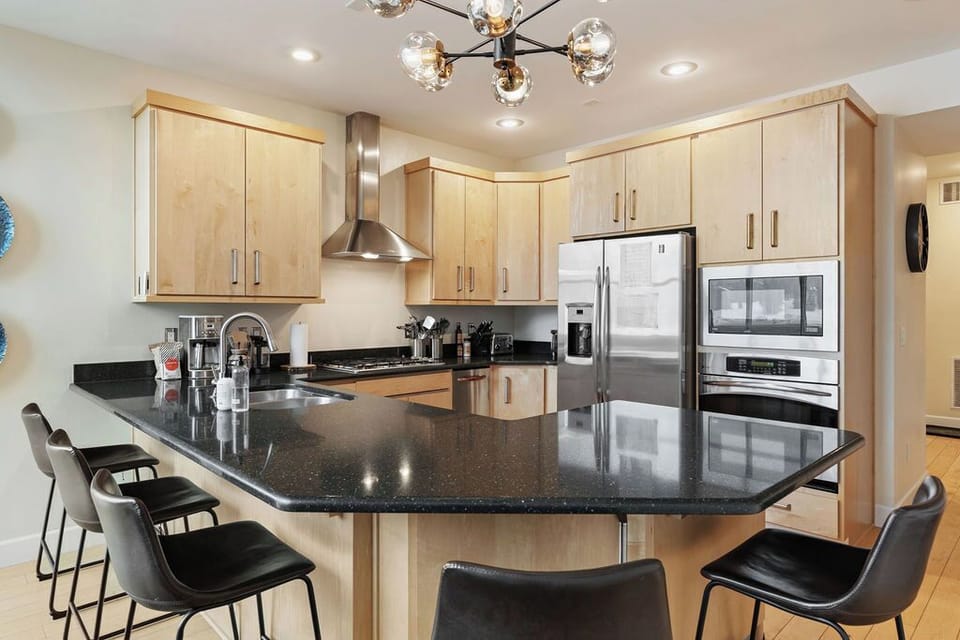 Whip up meals in this fully-equipped kitchen with a cozy breakfast table, just steps away from the living room! | The Juniper, Brian Head, Utah | Voyax Luxury Vacation Rentals