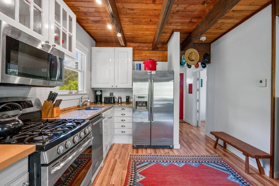 The living areas begin with the large galley style kitchen that runs the length of the wall
