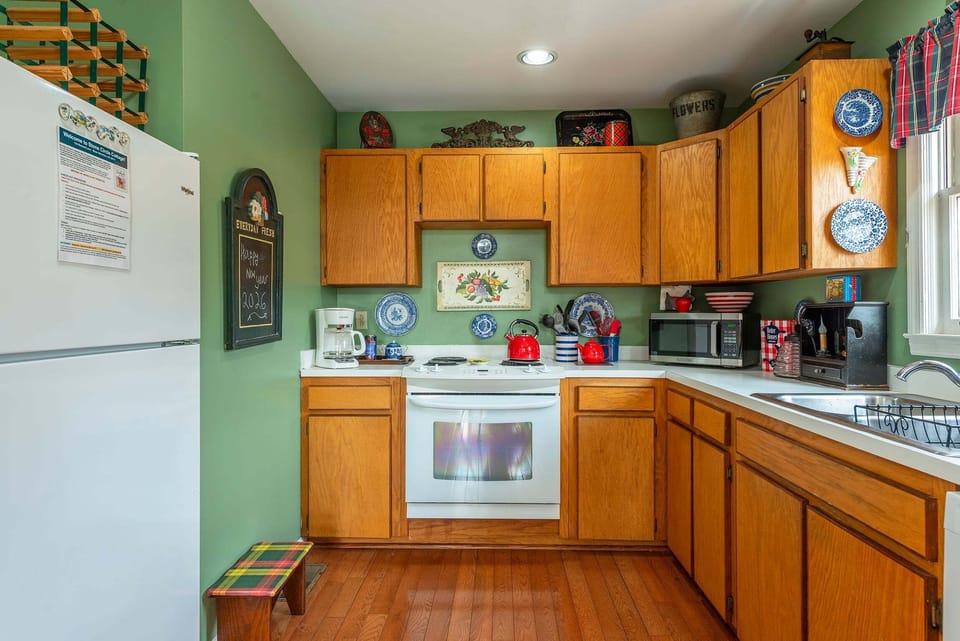 Kitchen with dishwasher, Dutch oven, blender, food processor & standard drip coffeemaker.