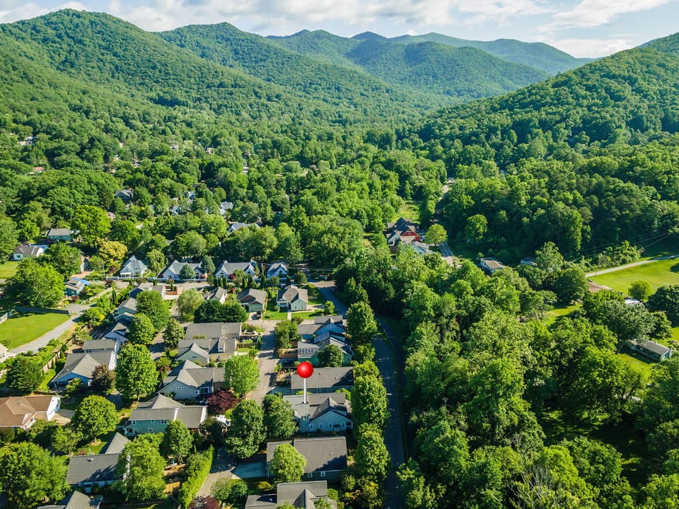 Located in the quiet community of Cotton Creek, this thoughtfully appointed cottage is only a 5-minute drive or 20-minute walk from the heart of downtown Black Mountain!