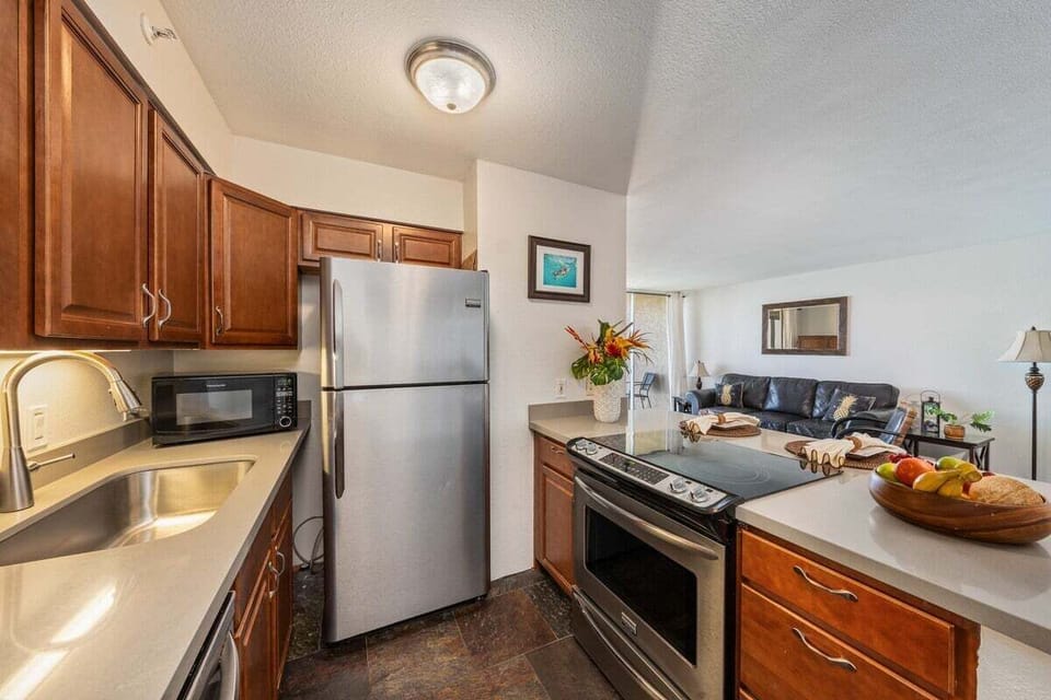 Prepare dishes in a kitchen of stainless steel and flowers, flowing seamlessly into the lounge.